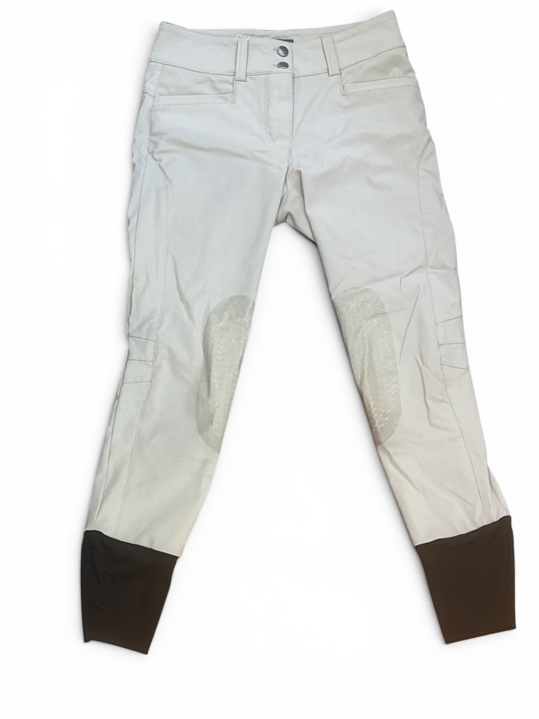 White riding pants with brown boot tops on a white background