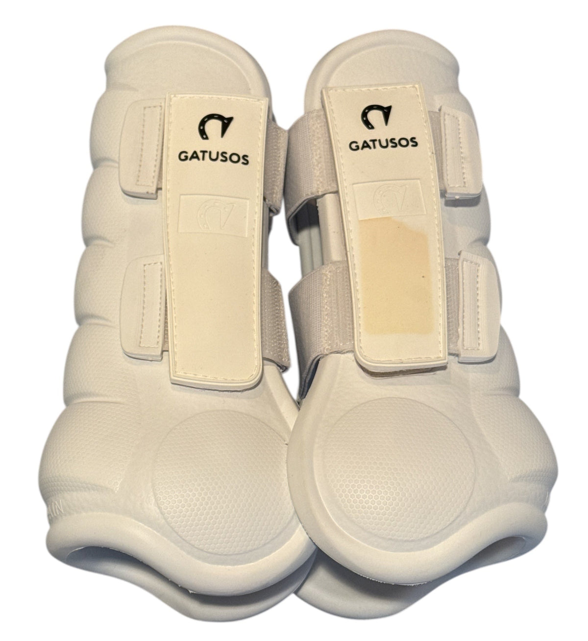 Pair of white protective horse boots with 'Gatusosos' branding on a white background