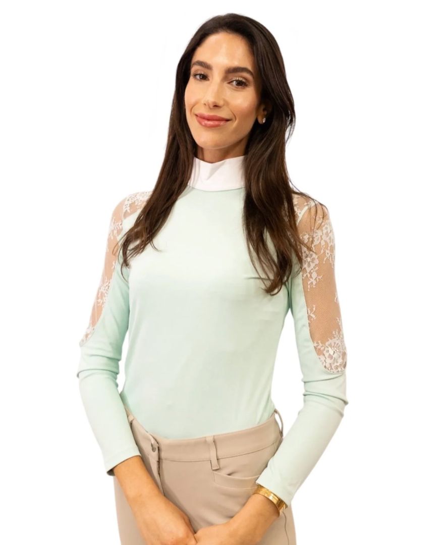 Woman wearing a light green top with lace sleeves on a white background