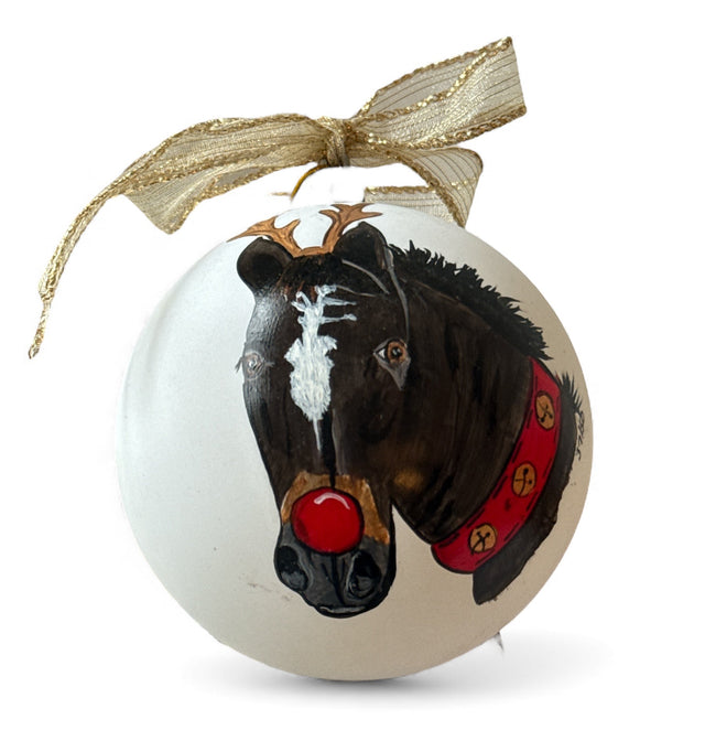Decorative ornament with a horse design and gold ribbon on a white background