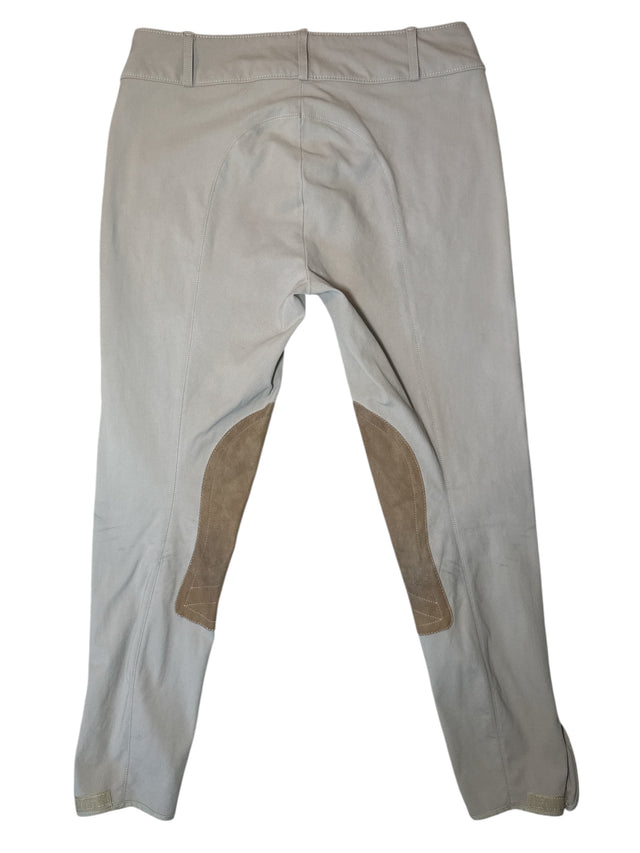Beige equestrian pants with brown patches on a white background