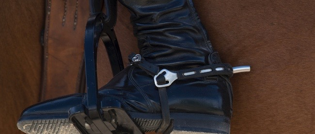equestrian tall boot and spur in a stirrup
