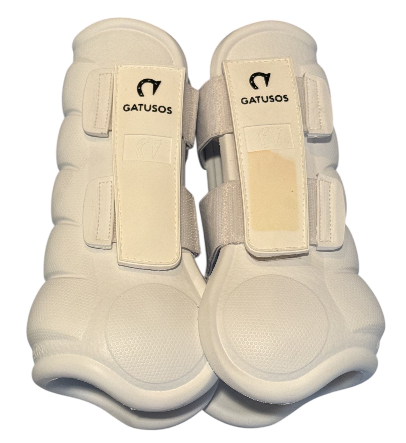 Pair of white protective horse boots with 'Gatusosos' branding on a white background