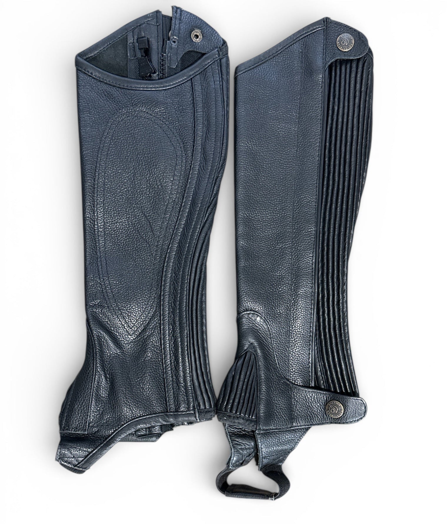 Pair of black leather gaiters on a white background