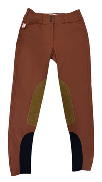 Brown riding pants with green knee patches on a white background