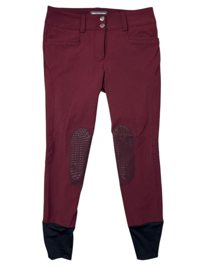 Maroon riding pants with knee patches on a white background