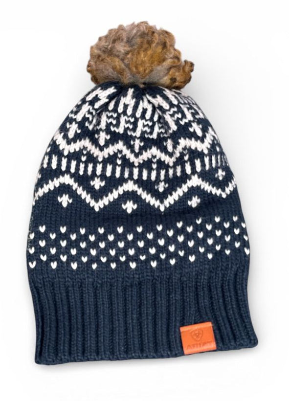 Navy blue knit beanie with white pattern and brown pom-pom on a white background