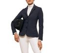 Person wearing a navy equestrian jacket with white pants on a white background