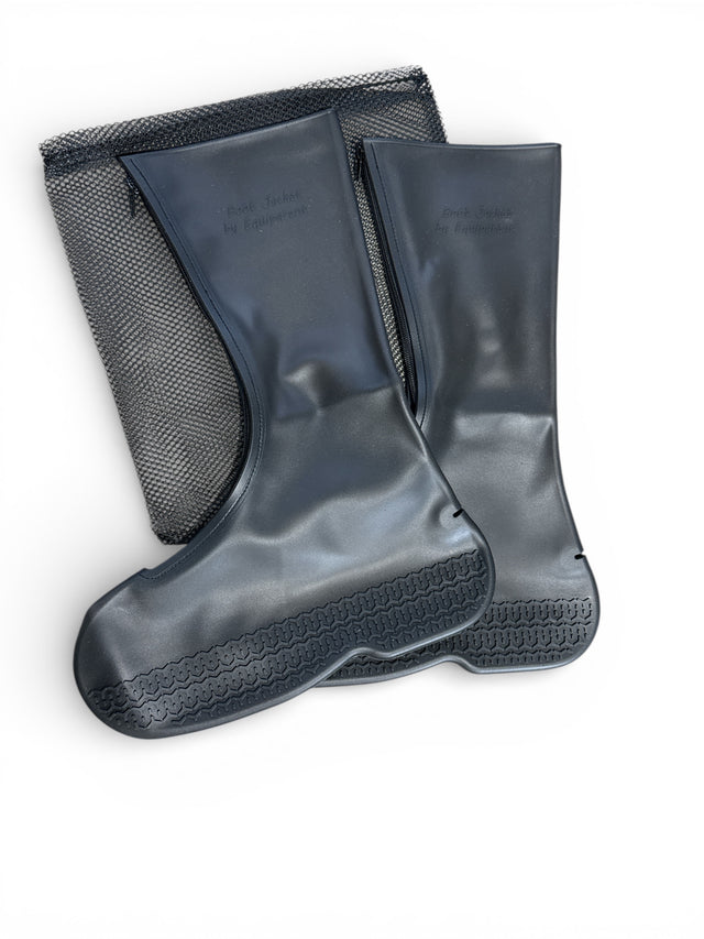 Pair of gray rubber boots with black soles on a white background