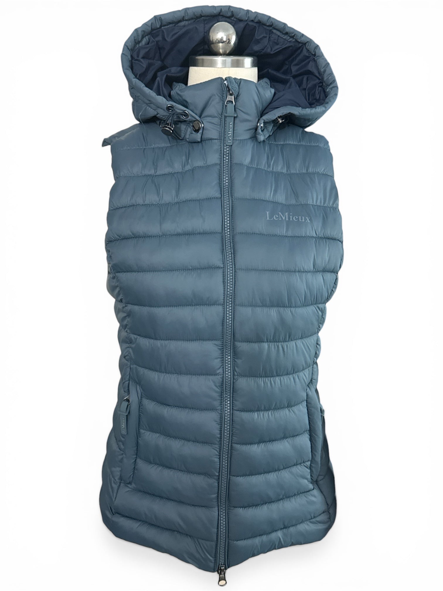 Blue puffer vest on a mannequin with a white background