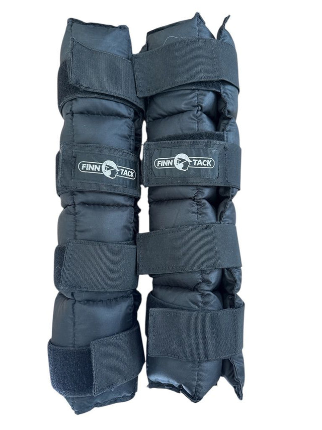 Pair of black horse leg wraps with Finn Tack branding on a white background