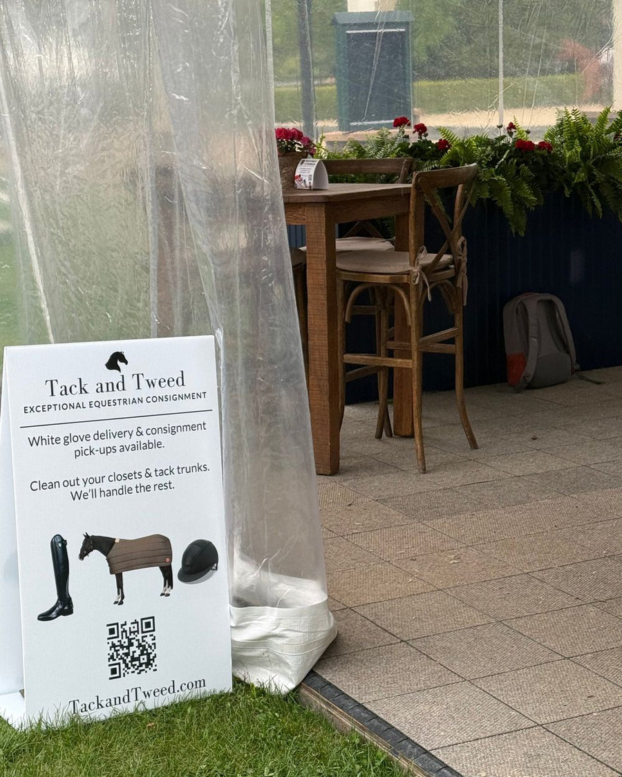 A Tack and Tweed sign on the lawn beside the hospitality tent.